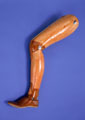 Photo of wooden leg against blue background